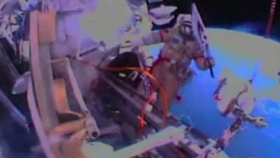 Cosmonauts take Olympic torch  on historic spacewalk
