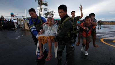 Desperate families beg for help along roads framed by typhoon devastation