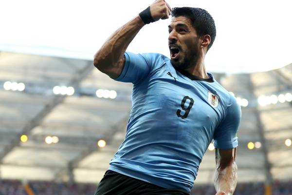 Luis Suarez marks 100th cap with goal to send Uruguay through
