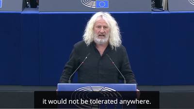 Mick Wallace caps China visit by revealing new ‘no war’ tattoo on state television