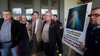 Protesters interrupt repossession hearings with holy water