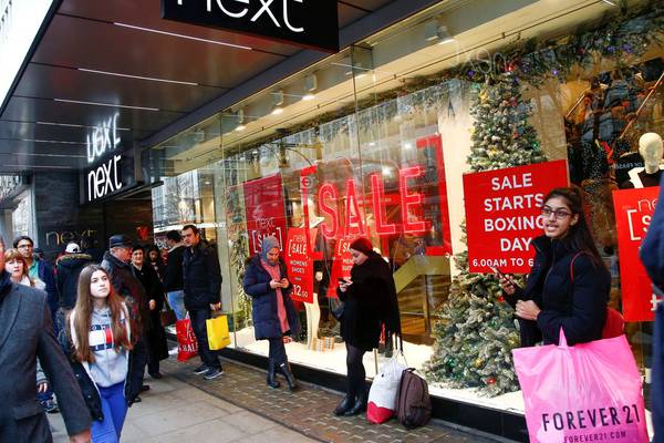 Next Christmas sales rise but company trims full-year profit guidance