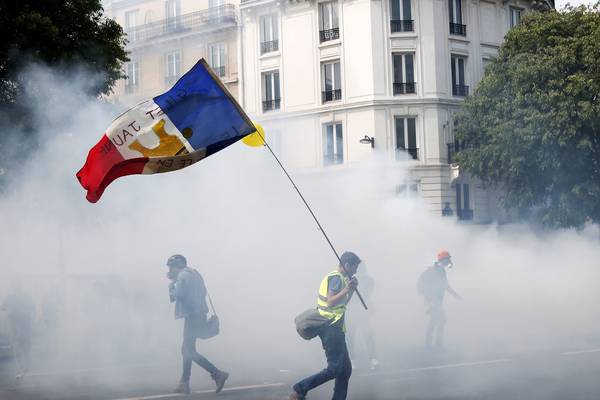 Police in Paris fire tear gas to repel protesters on May Day rally