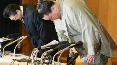 Sumo grand champion retires over assault claims