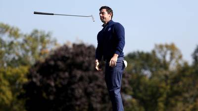 Rory McIlroy tries in vain to stem the flow of red tidal wave