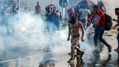 Stones and tear gas fly as migrant tension erupts