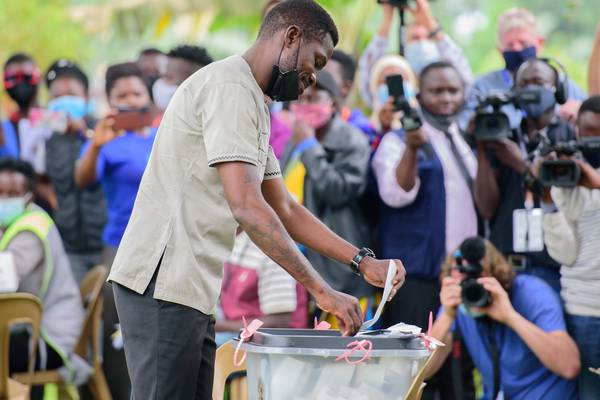 Ugandans choose between pop singer and longtime leader in tense election