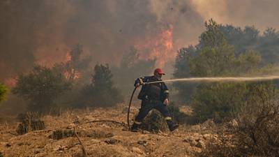 UN weather agency warns of little respite in ‘summer of extremes’ as wildfires burn Greek homes