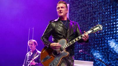 Josh Homme of Queens of the Stone Age kicks female photographer in head