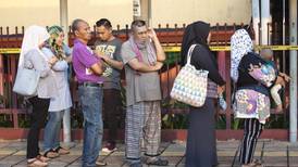 Malaysia’s ruling coalition holds slight lead in election count