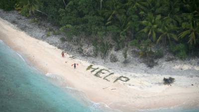 Three men rescued after spelling ‘help’ with palm leaves