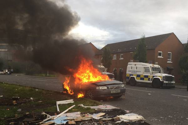 Belfast police call for calm after cars and a building set on fire