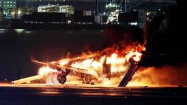 Nearly 400 escape burning airliner on Tokyo runway as two-plane collision leaves five dead