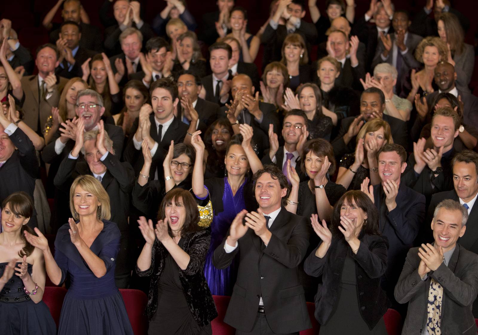 Clapping theater audience standing ovation