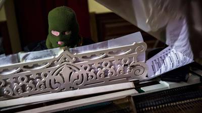 Masked maestro makes piano weapon of choice on Kiev streets