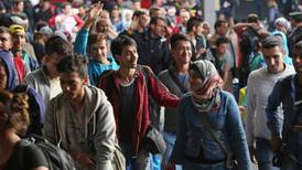 Thousands of exhausted migrants and refugees arrive in Austria and Germany