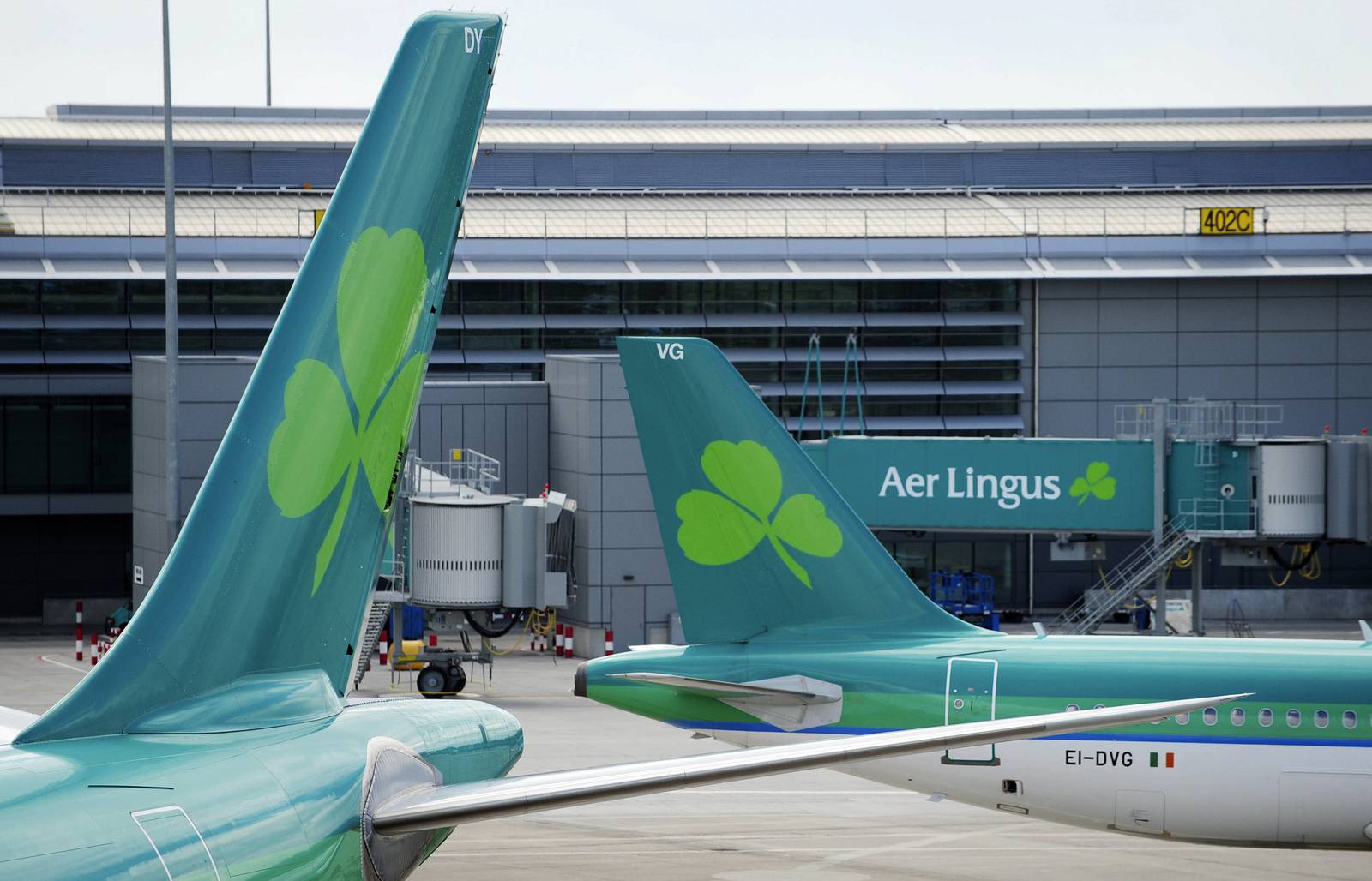 Aer Lingus aircraft, operated by Aer Lingus Group Plc, pass each other at Dublin Airport in Dublin, Ireland, on Thursday, June 9, 2011. Aer Lingus Group Plc's total booked passenger numbers rose 4 percent to 911,000 in May from the year earlier. Photographer: Aidan Crawley/Bloomberg