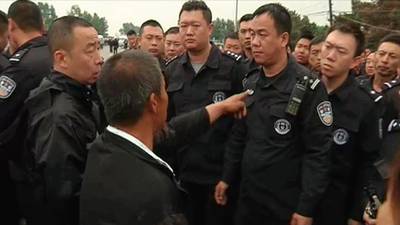 Relatives scuffle with police after 120 die in China plant fire