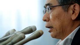 BOJ keeps stimulus in place, cuts view on exports in warning sign