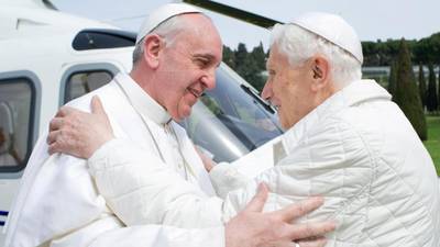 Pope Francis kneels in prayer with predecessor Benedict