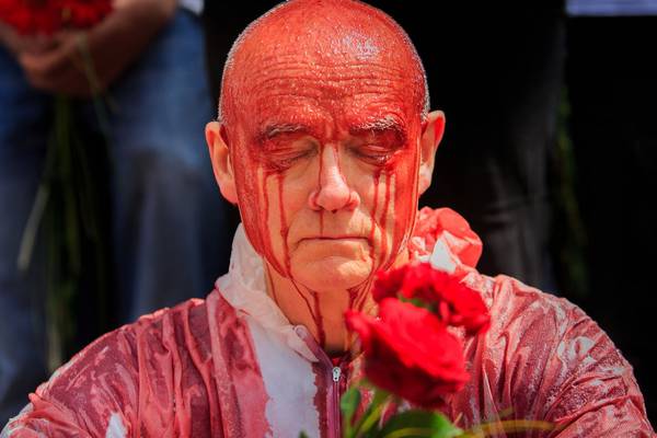 Activists douse themselves in fake blood in climate protest