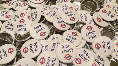 ‘Tube Chat?’ badges appear on London underground
