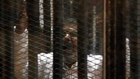 Morsi legal team walks out in protest over courtroom cage