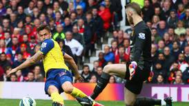 Deflected Theo Walcott goal earns Arsenal a point at Old Trafford