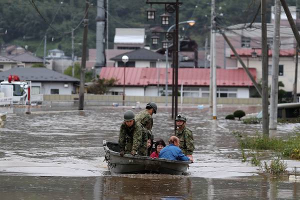 Typhoon Hagibis: Rescuers wade in muddy waters to find survivors