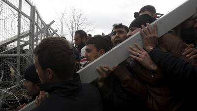 Migrants in Greece break gate on border with Macedonia