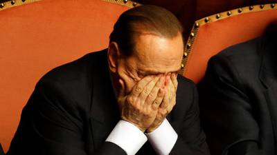 High drama in Italian parliament as Berlusconi changes mind and backs government