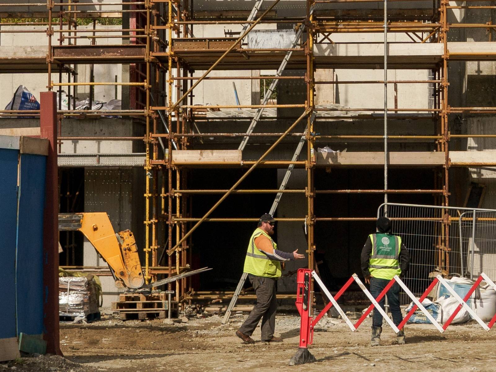 Workers monitor a crane lifting materials at a construction site in the Sandyford district of Dublin, Ireland, on Tuesday, May 11, 2021. The mass purchase of affordable houses  on the market for about 400,000 euros ($490,000)  set off a public firestorm and highlights the growing tension over the squeeze in urban housing and the role of large investors. Photographer: Paulo Nunes dos Santos/Bloomberg