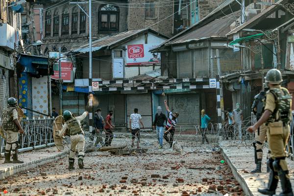 Police in Kashmir use tear gas as at least 10,000 protest