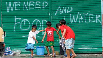 Filipino authorities lower typhoon Haiyan death toll