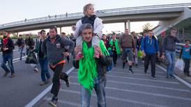 Hundreds of migrants march to border on Hungarian motorway