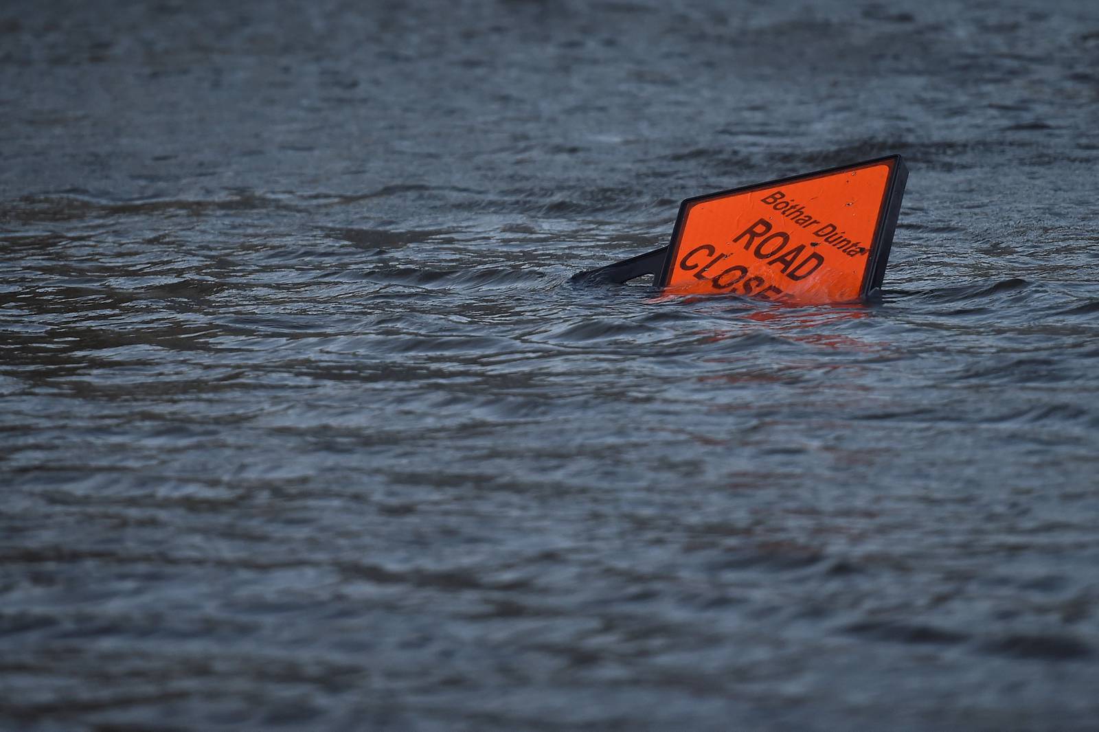 A 'road closed' sign is seen submerged in floodwater during Storm Ophelia in Galway, Ireland October 16, 2017. REUTERS/Clodagh Kilcoyne