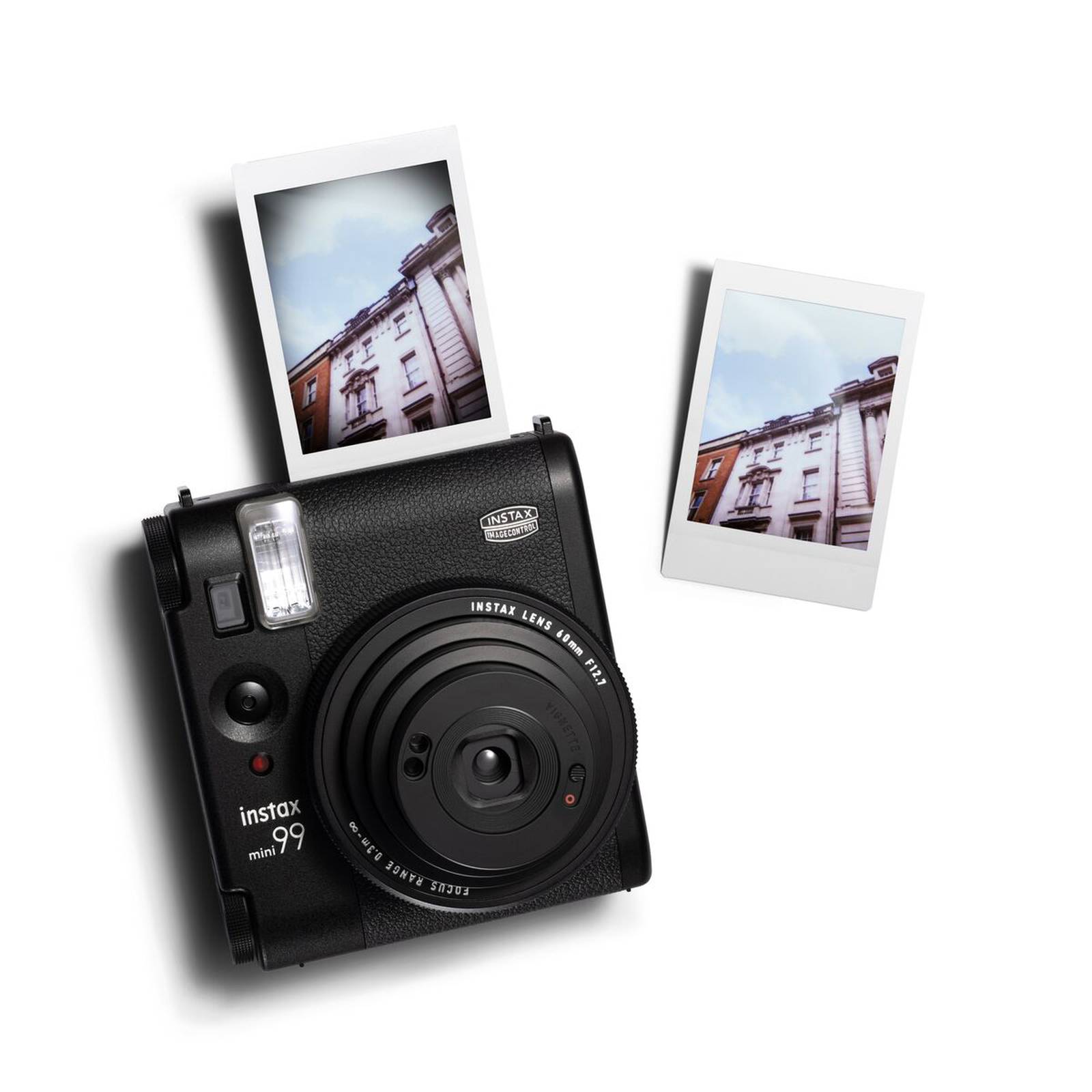 A black, old-style instant camera with a photograph being produced from the top of the device.