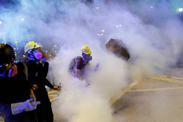 Thousands protest in Hong Kong as China media issues warning