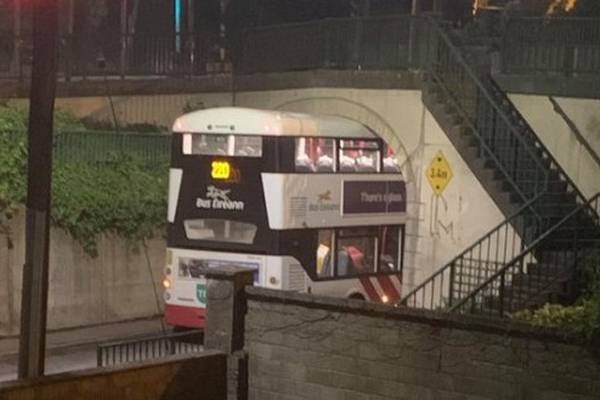 Double decker bus takes wrong turn and gets wedged under bridge in Cork