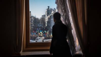Ukraine government holds on as Yanukovich heads for China