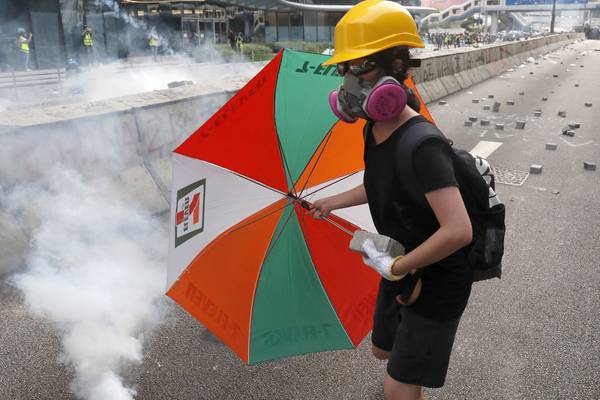 Hong Kong police use tear gas to break up protesters as thousands take to streets