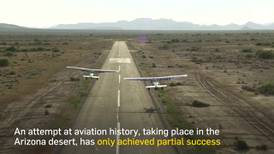 World's first mid-air 'plane swap' stunt only partially successful