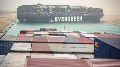 Ten tug boats try to free huge container ship blocking Suez Canal