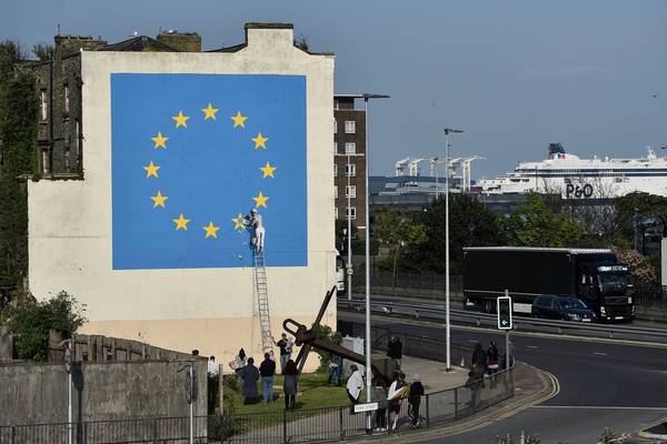 Brexit mural by Banksy in Dover shows man chipping away at EU flag