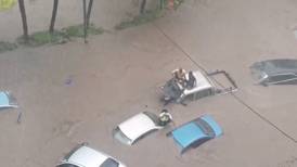 Motorists left stranded on car roofs as Cyclone Belal inundates Mauritius