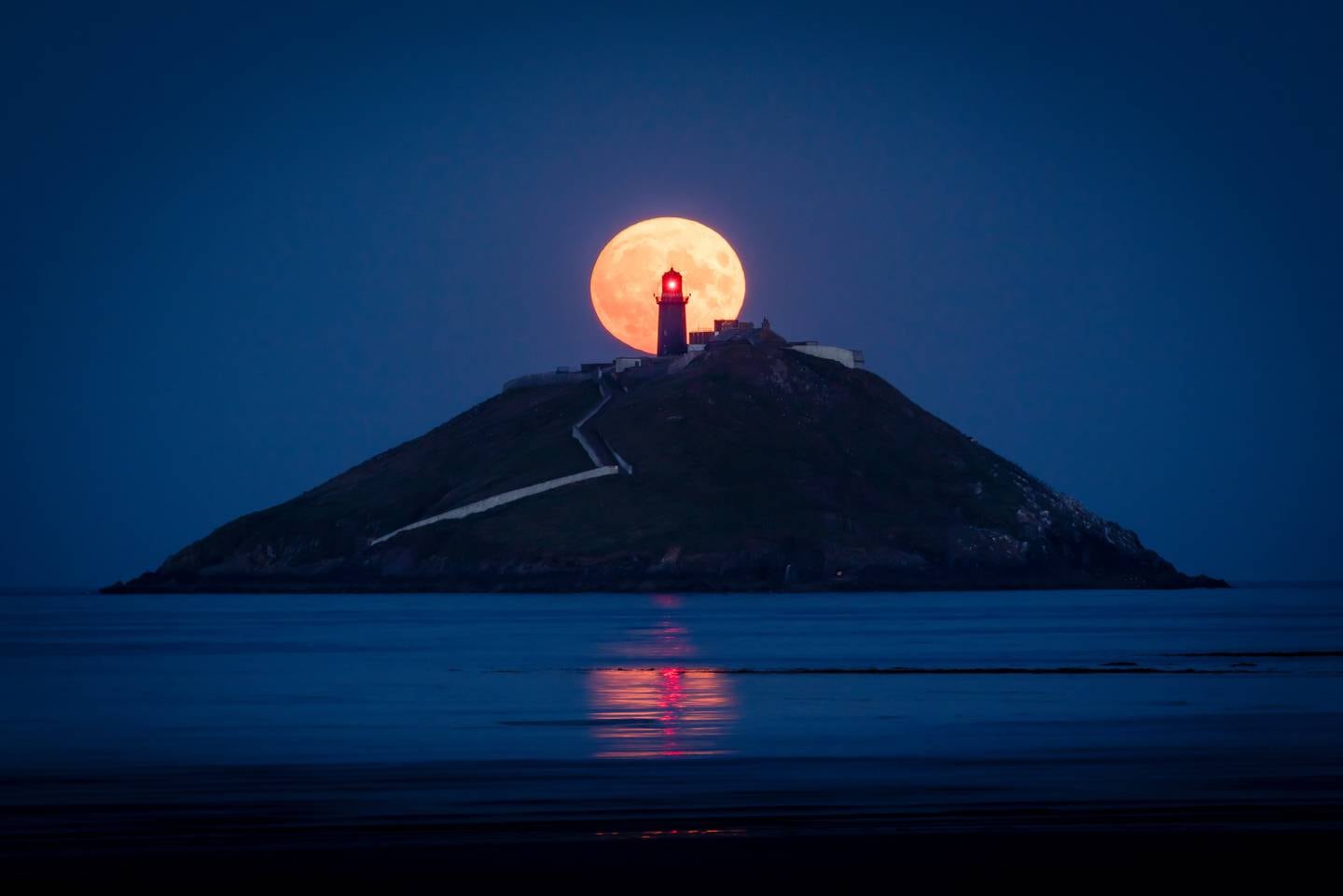 Coastal Heritage Category 
1st Place

Karol Ryan - Sturgeon Moon, Ballycotton - Ballycotton, Co. Cork

Karol Ryan stated of this winning image, “I had been to this location the previous month to try and capture this image but the weather didn't work in my favour, but the next month on 11th August the conditions were perfect & I managed to get the shot I was after.”