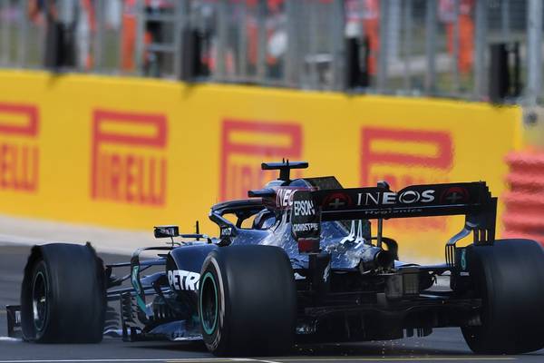 Lewis Hamilton defies puncture to win British Grand Prix