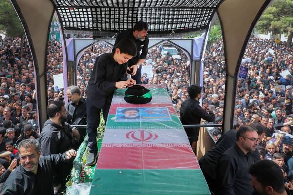 Iran buries president Ebrahim Raisi and others killed in helicopter crash at holy shrine