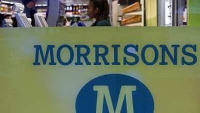 Grocer Morrisons first-half profit more than halves