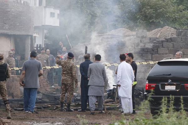 At least 18 killed after Pakistani military plane crashes into house